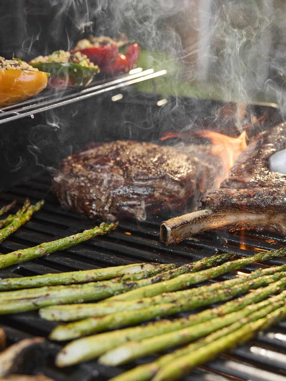 Steak and vegetables on Weber BBQ grill (portrait)
